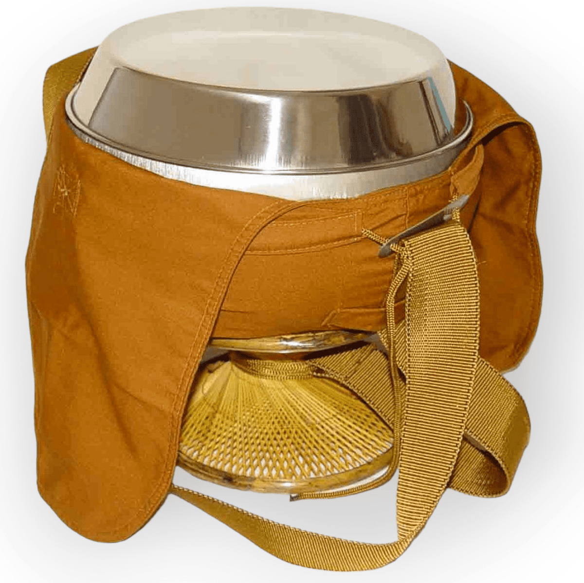 Stainless steel monk alms bowl in an orange cloth cover with shoulder strap on a rattan stand, front view