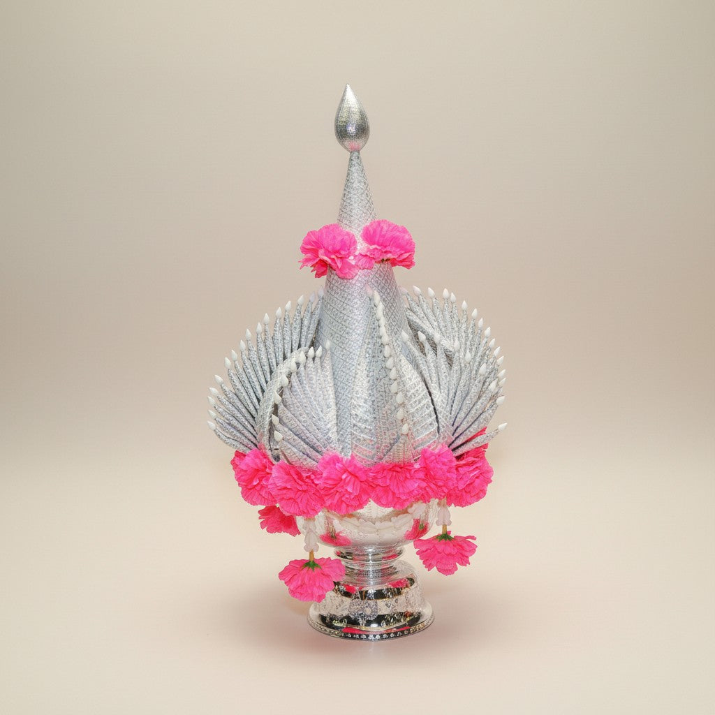 Silver Buddhist altar decoration with pink flower garlands
