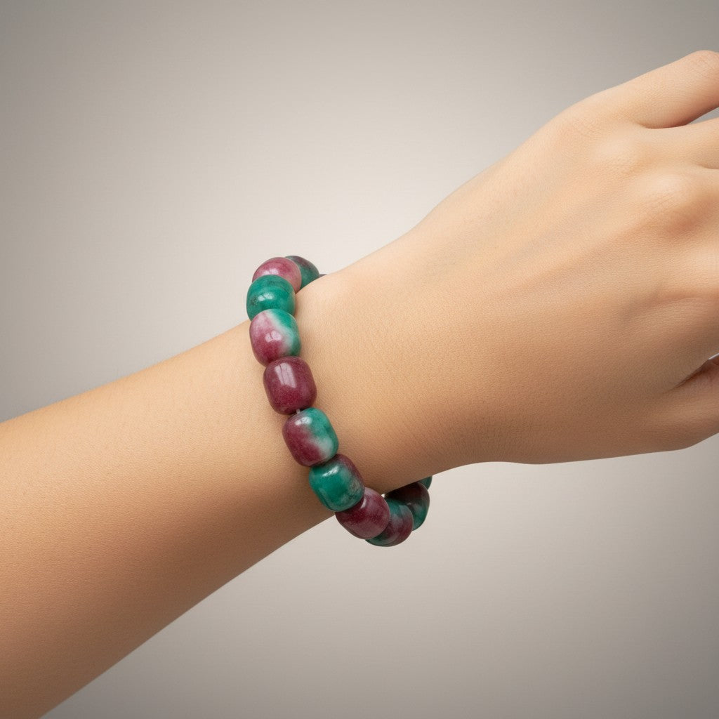 Multi-color jade bead bracelet with maroon and teal-green barrel beads worn on a wrist