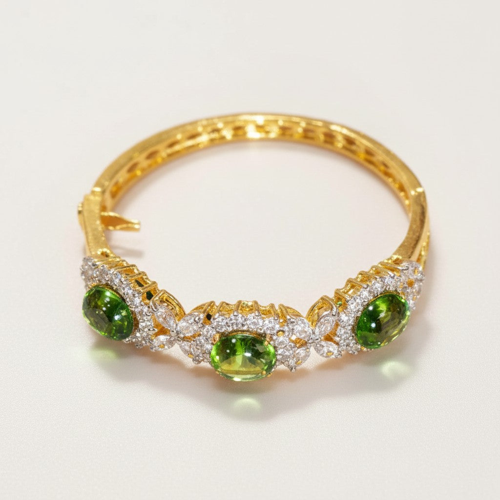 Dipped gold bangle with light green cabochon stones and clear stone accents
