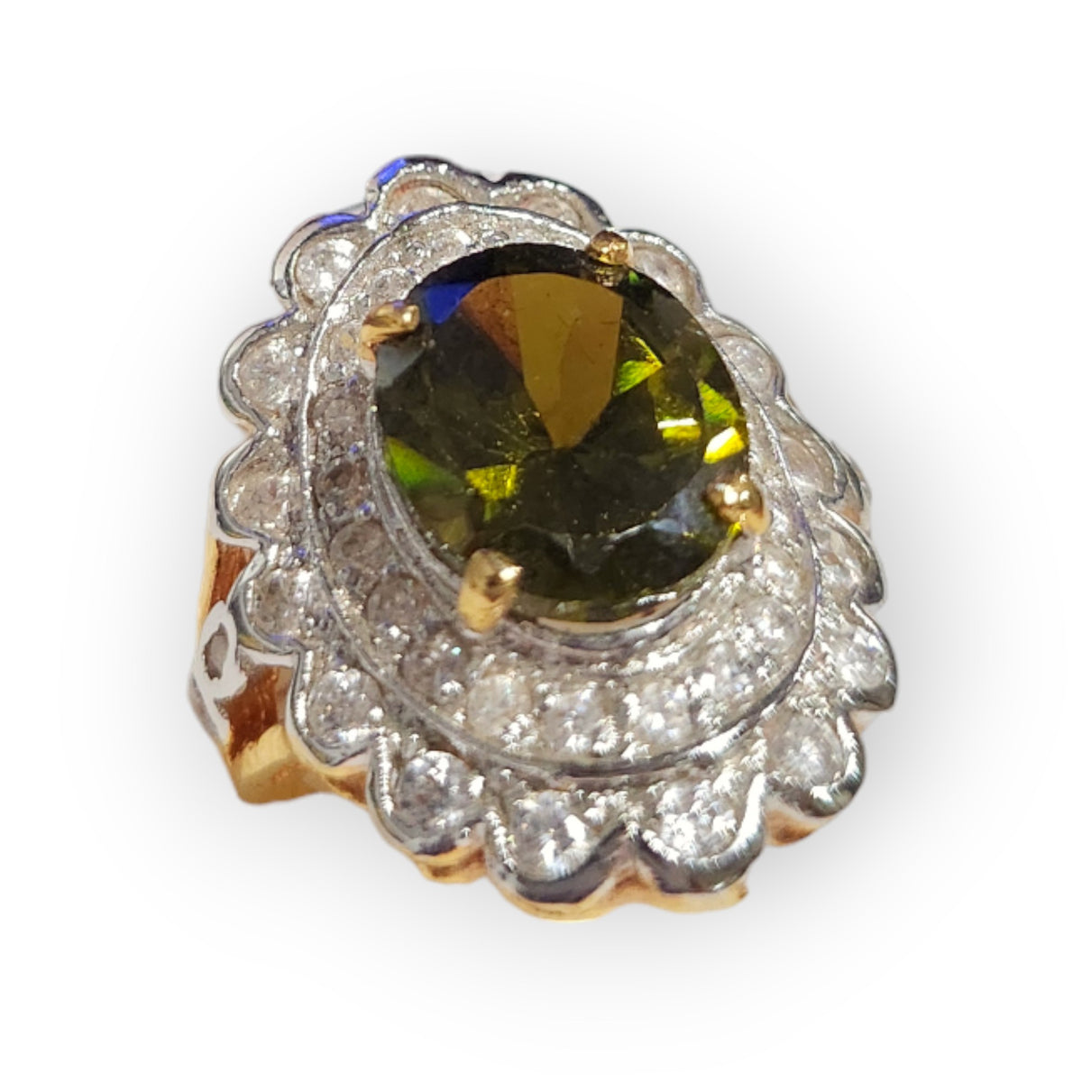 Another view of the gold-dipped size 7 ring with an oval green peridot center and a scalloped halo of clear stones