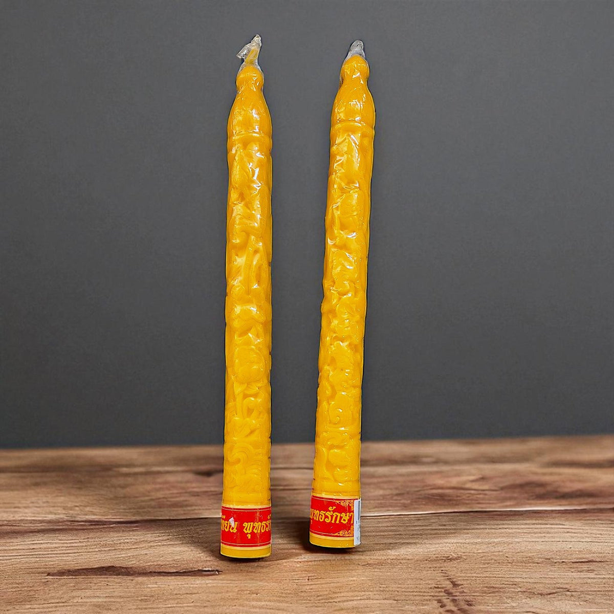 Pair of yellow temple candles, second view