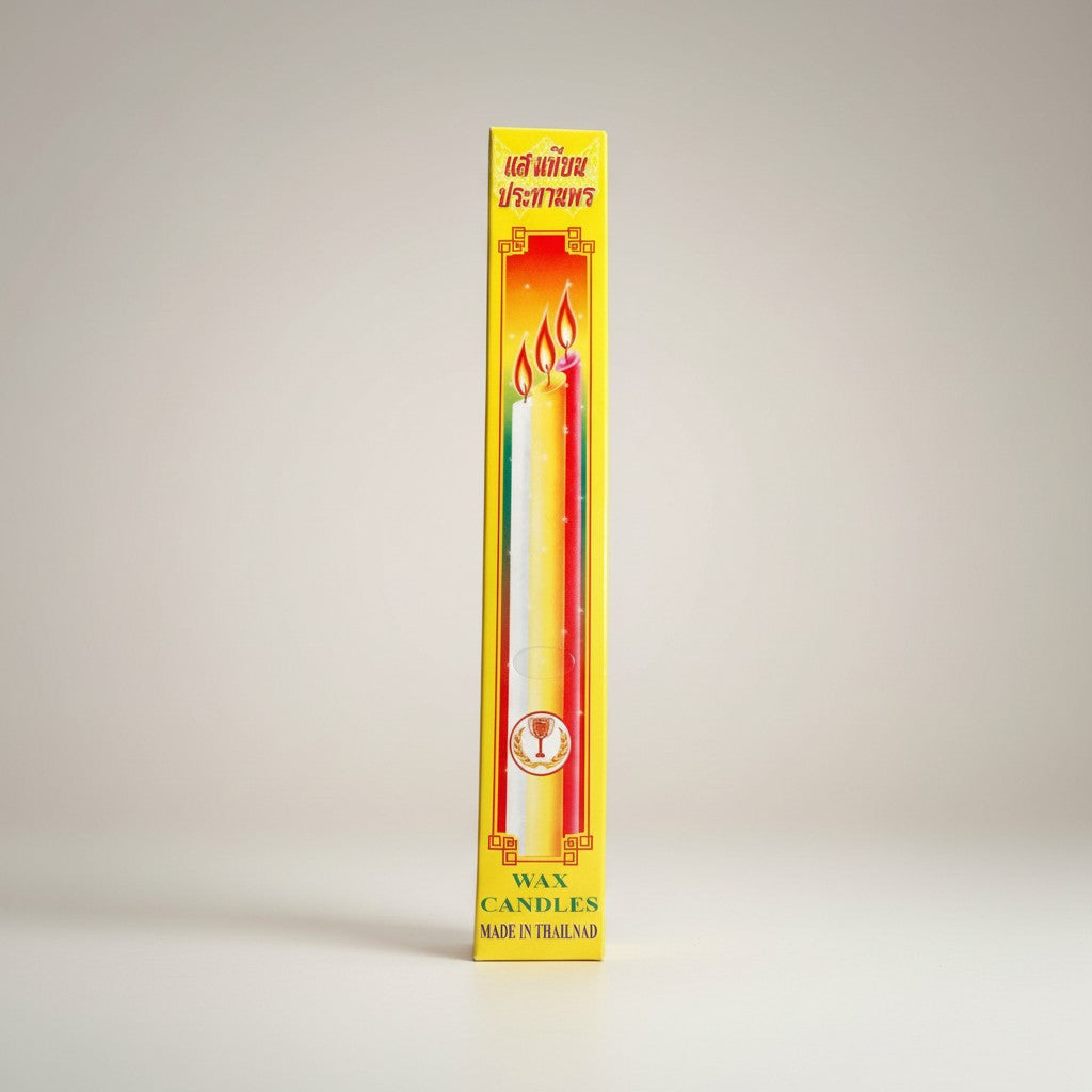 Boxed pair of 8 inch Buddhist ceremonial wax candles in a yellow and red box, on a gray background