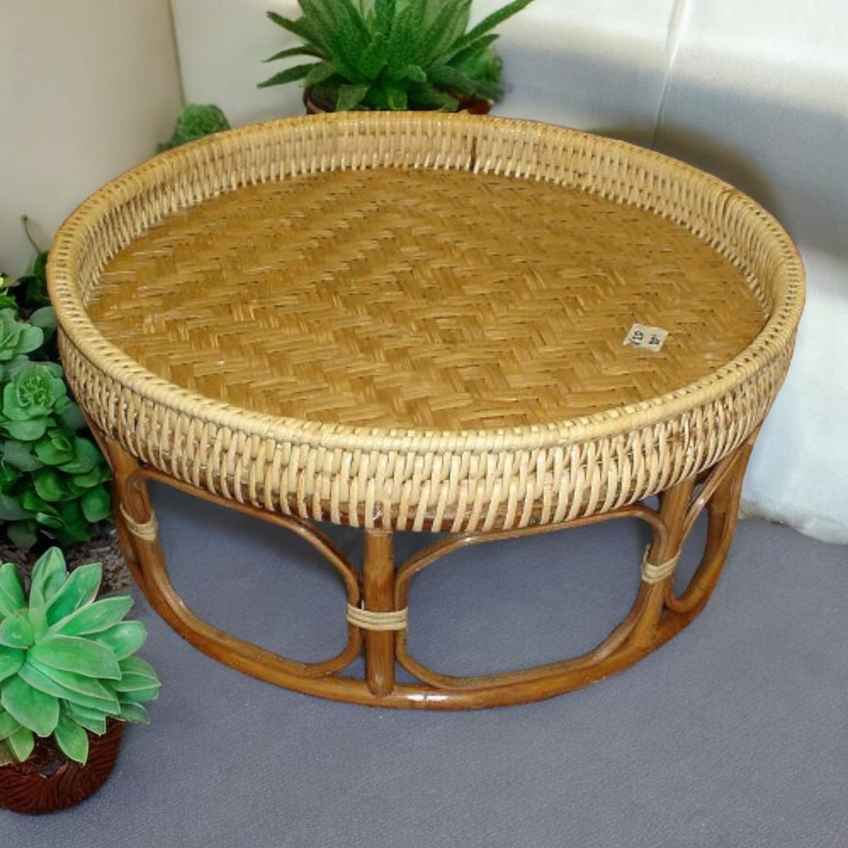 Rattan Khan Toke serving tray table with woven top, indoor view