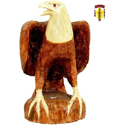 Carved wood bald eagle with wings raised on a natural base, front view