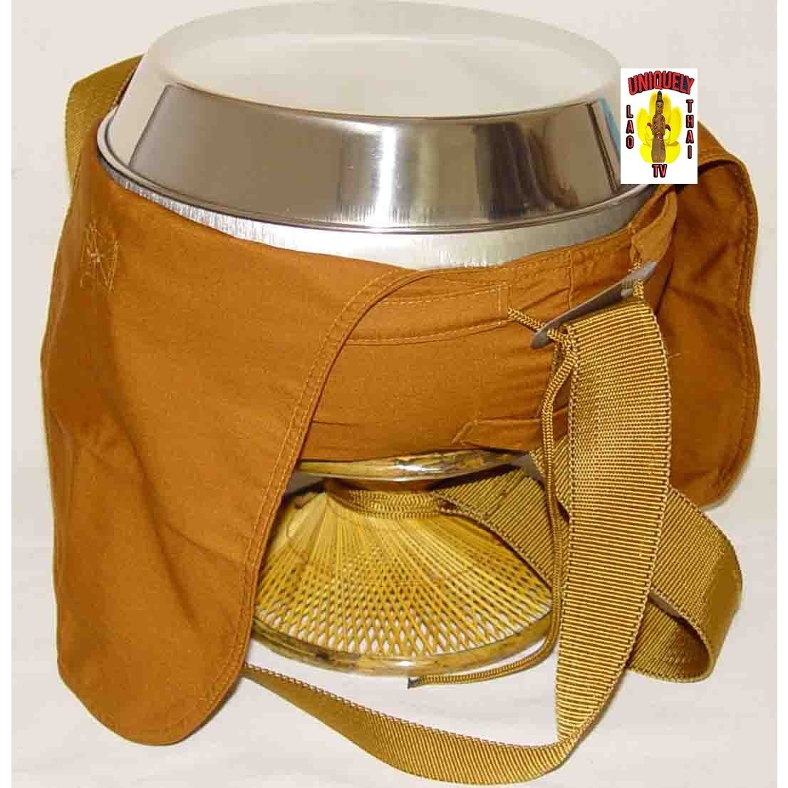 Close view of the alms bowl rim and orange cloth cover, with the shoulder strap and rattan stand below