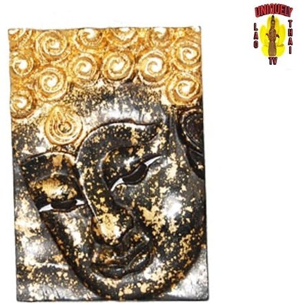 Close view of the black Buddha face plaque with silver flecks and a gold swirl topknot