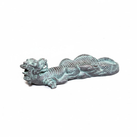 Long dragon figure in a green-blue finish, lying flat