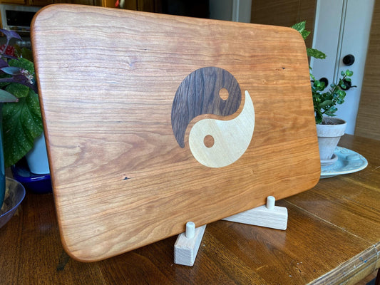 Cherry charcuterie board with Yin Yang inlay made from Peruvian Walnut and Maple.