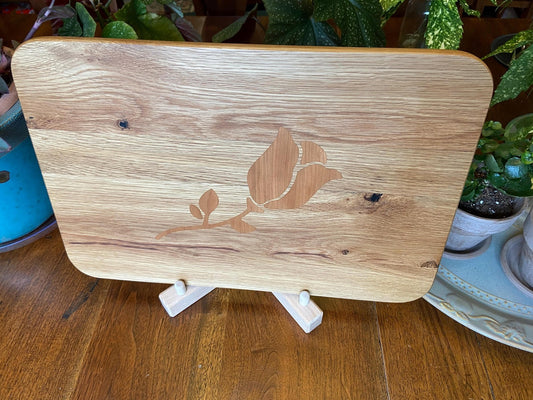White Oak charcuterie board with subtle rose and stem inlay made from Cherry.